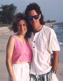Photo of Carol & Mighk Wilson from 1993, shortly after they met, standing on a beach in Casey Key, FL.