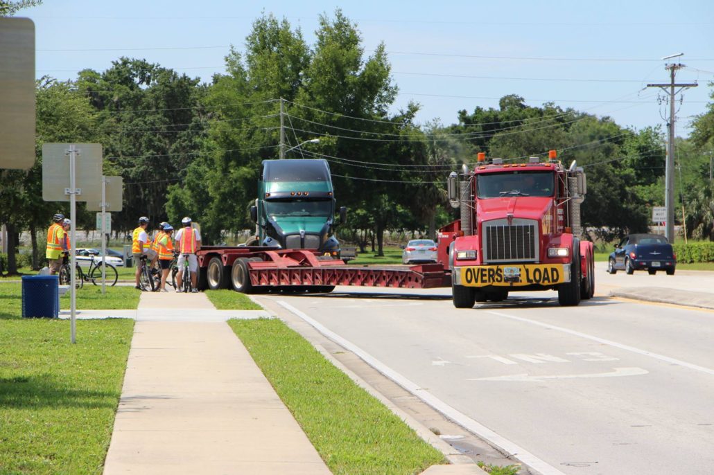 Big truck off-tracking onto sidewalk, within inches of FDOT staff standing on it!