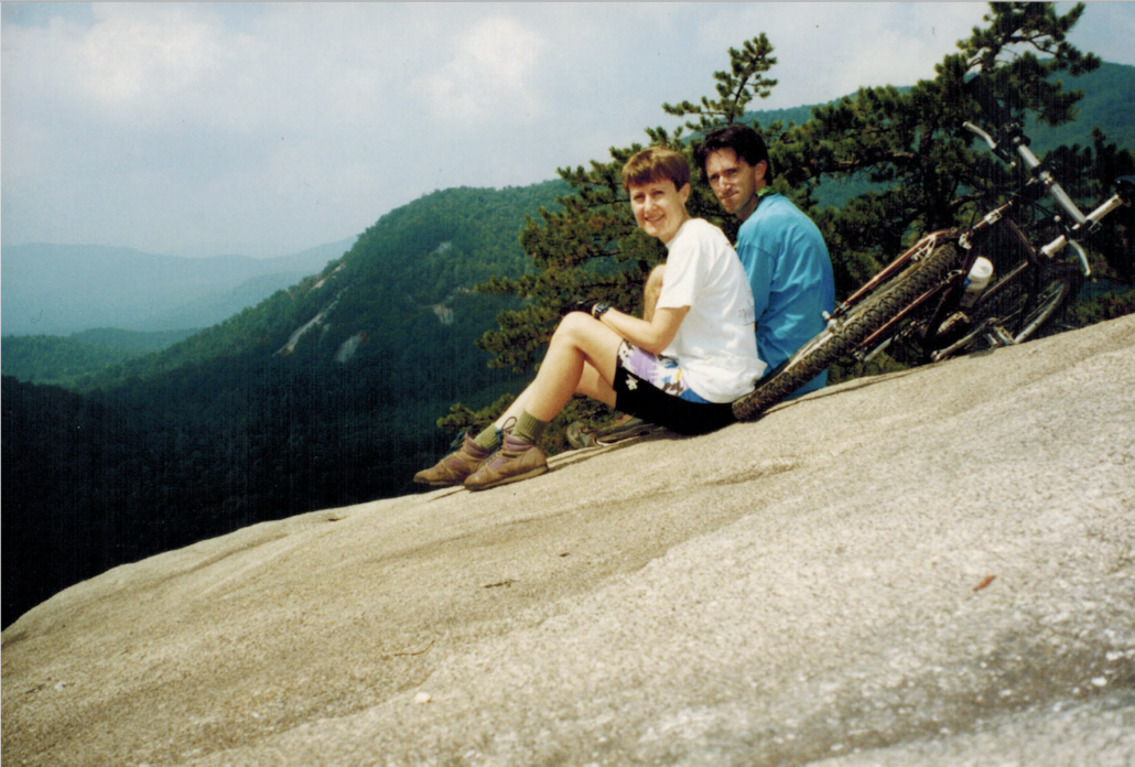 Photo of Carol and Mighk Wilson and their bicycles on a bald rock in DuPont State Forest in North Carolina.