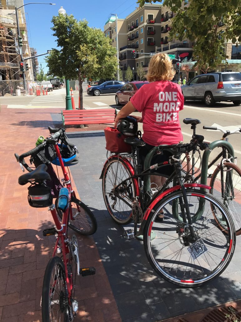 Lisa Brady in Downtown Boise with her bike and T-shirt's excellent message