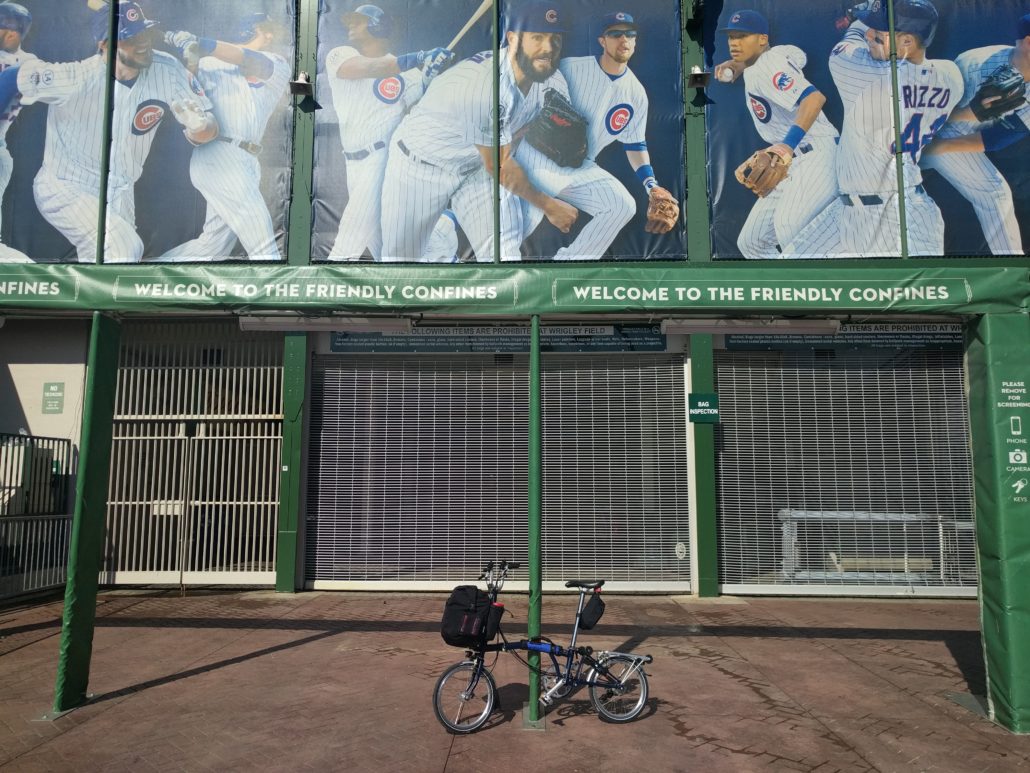Brompton bicycle leaning on the gate to Wrigley Field.