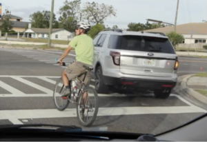 cyclist to left of lane allows motorist to turn right