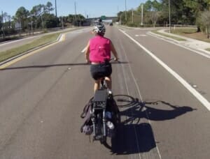 cycling using bicycle helmet mirror on wide open road