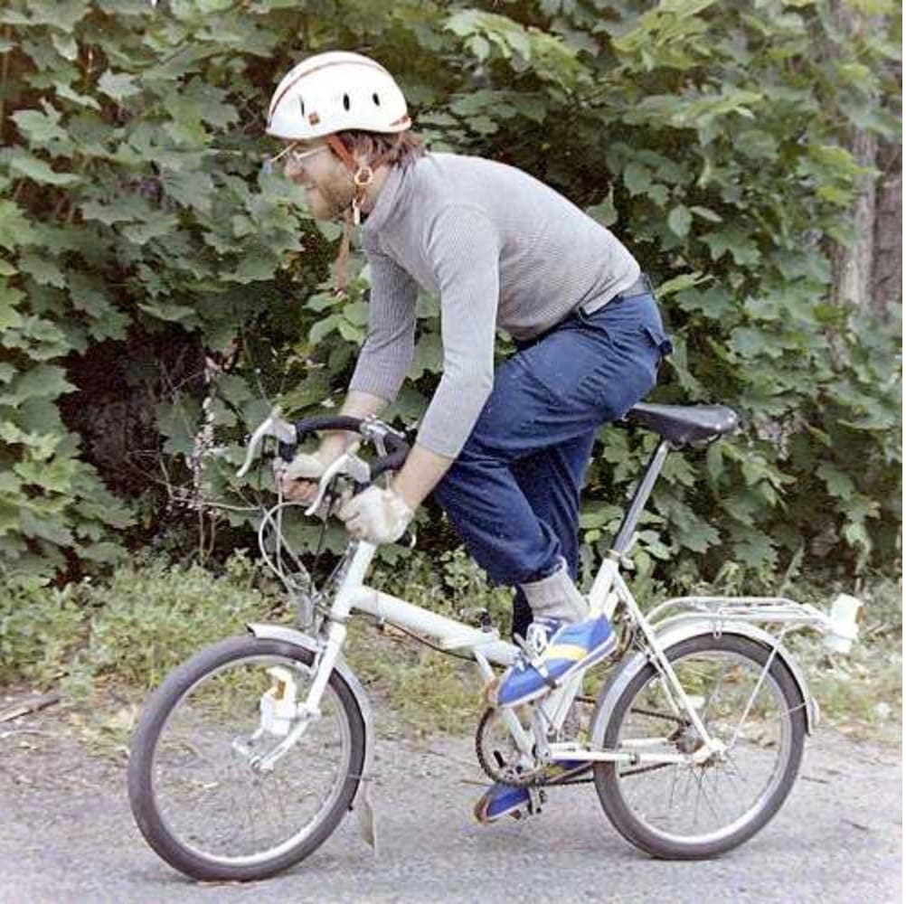 John S. Allen riding a folding bicycle