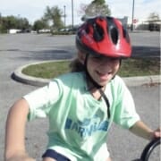 girl on bike with a big smile