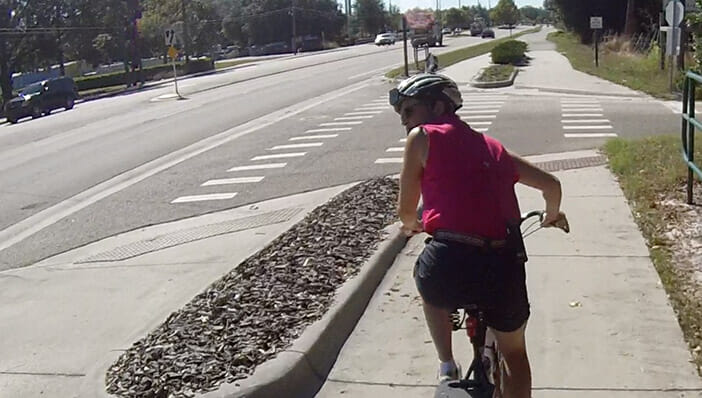 Bicyclist using pedestrian behavior: scan back on sidepath