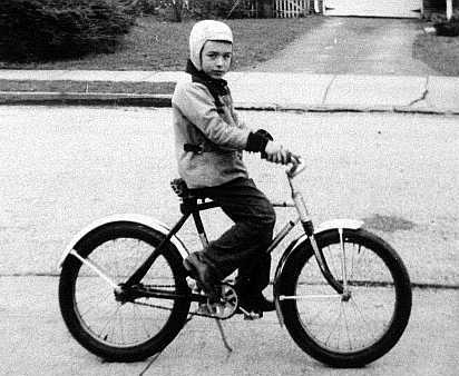 John Allen, age 7, on his first bicycle