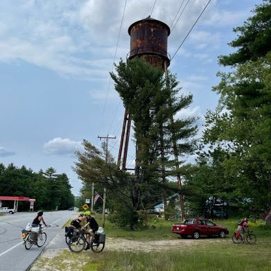 Bicyclists arrive at the People's Perch in East Baldwin, Maine with its 200-foot water tower. 