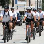 Police officers riding double file.