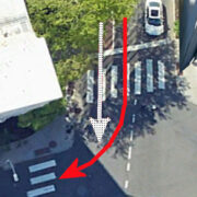 Car turning right on red right hooks city bus